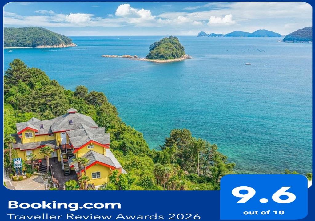 an image of a house on a hill next to the ocean at Arasol Pension in Geoje