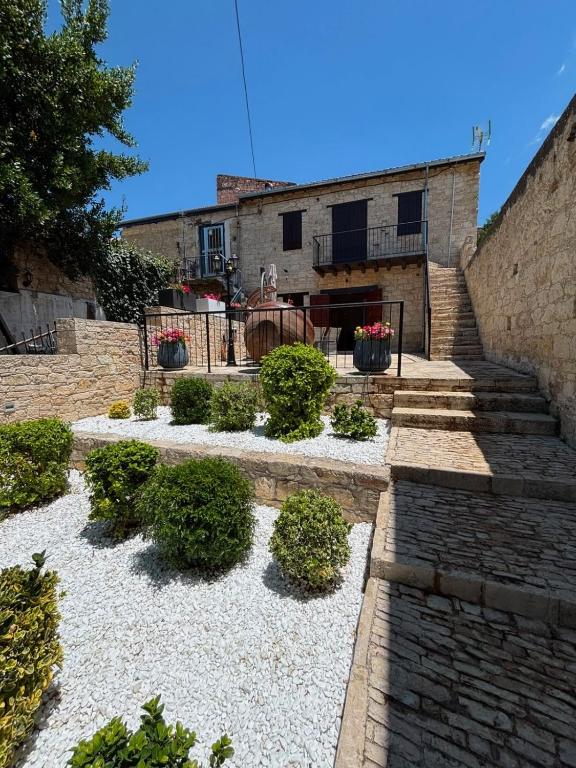 a building with stairs and plants in front of it at Arsos Nest in Arsos