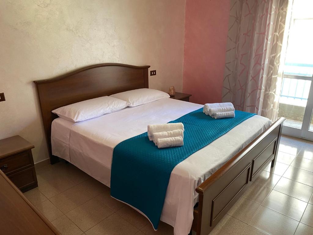 a bedroom with a bed with two pillows on it at Casetta in Centro in San Salvo