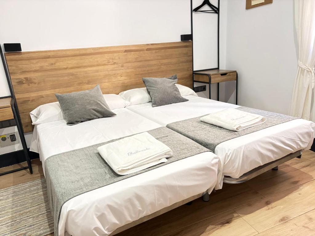 a bedroom with two beds with towels on them at Balhondo Open Village in Puebla de Alcocer