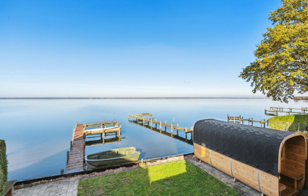 a dock with a boat on the water at Panoramablick am Steinhuder Meer in Steinhude