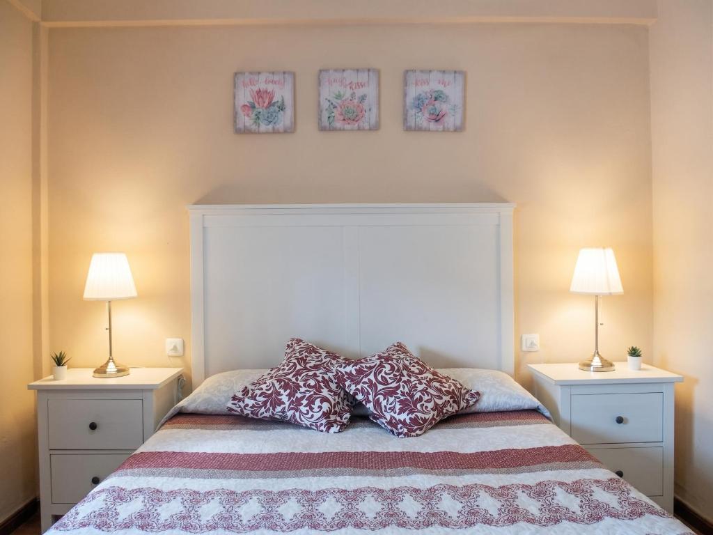 a bedroom with a bed with pillows and two lamps at Comfortable Apartment Ayamonte Garden in Ayamonte