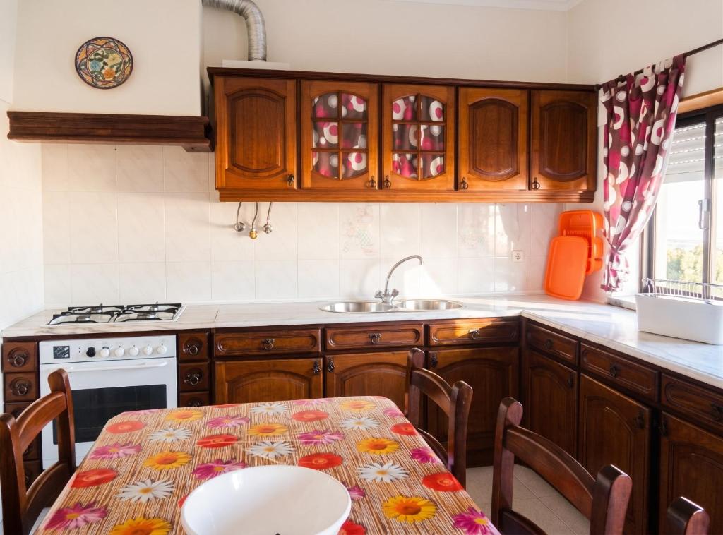 a kitchen with a table and a sink at Sea View Apartment in Peniche in Peniche