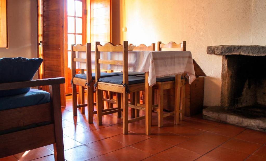 a dining room table and chairs with a fireplace at Comfortable Apartment in Seia with Terrace and Fireplace in Seia
