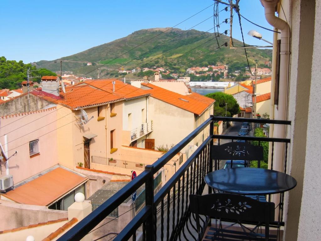 a balcony with two chairs and a view of a city at Appartement avec vue sur mer à Port-Vendres, 60 m², balcons. in Port-Vendres