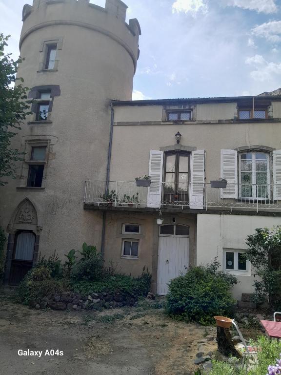 an old building with a lighthouse on top of it at Chambres d'hôtes de charme "La Tour Richelieu" in Martres-de-Veyre