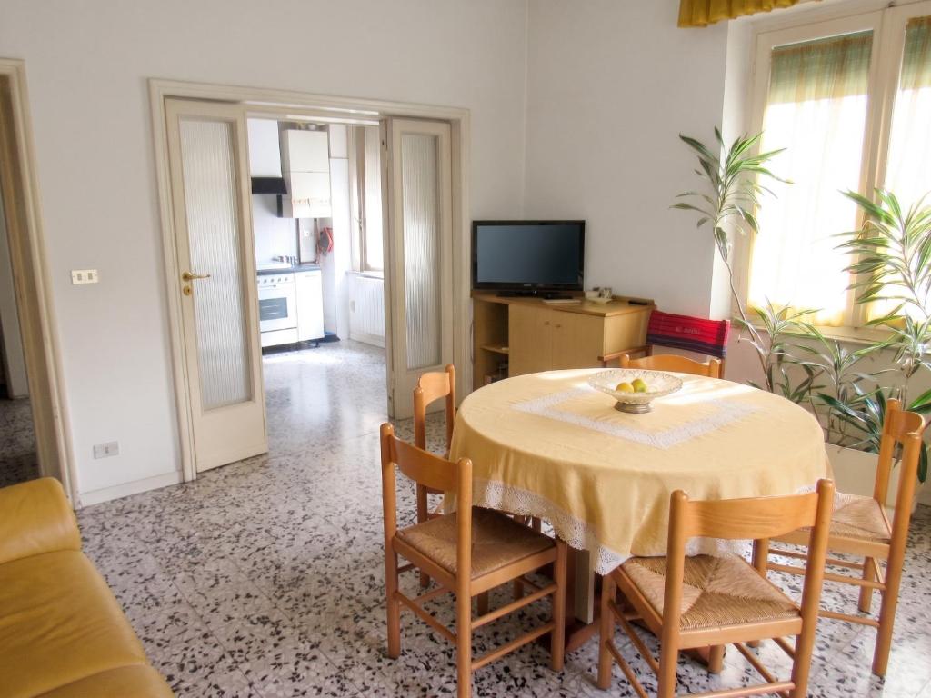 a dining room with a table and chairs and a television at Spacious Apartment in Pescara, 120 m², Ideal for Families in Pescara