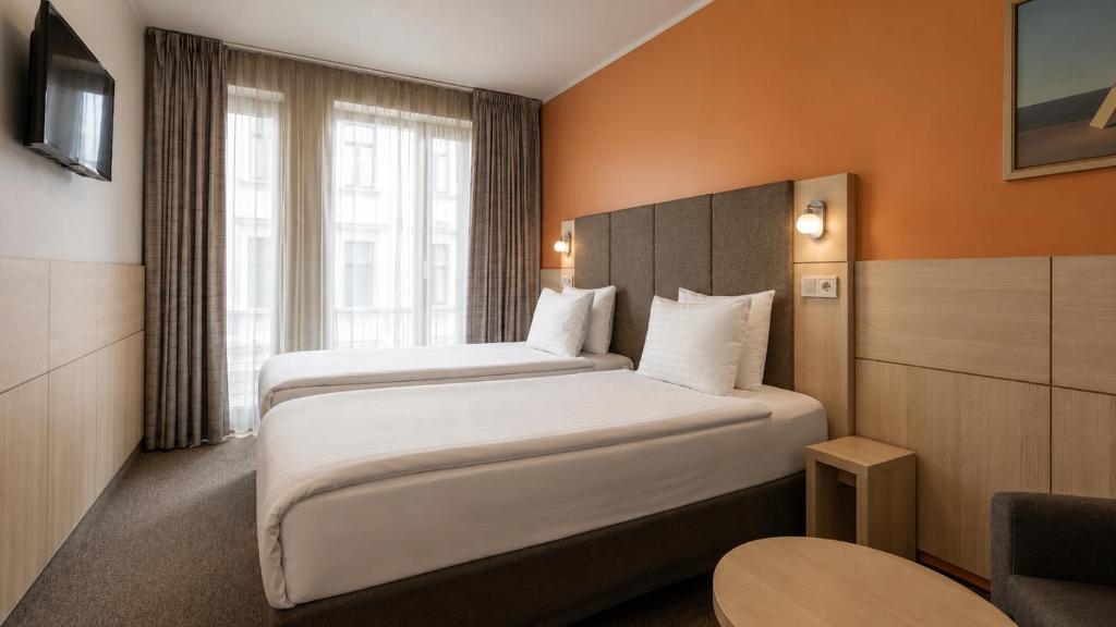 a hotel room with two beds and a window at Wellton Riga Hotel & SPA in Riga