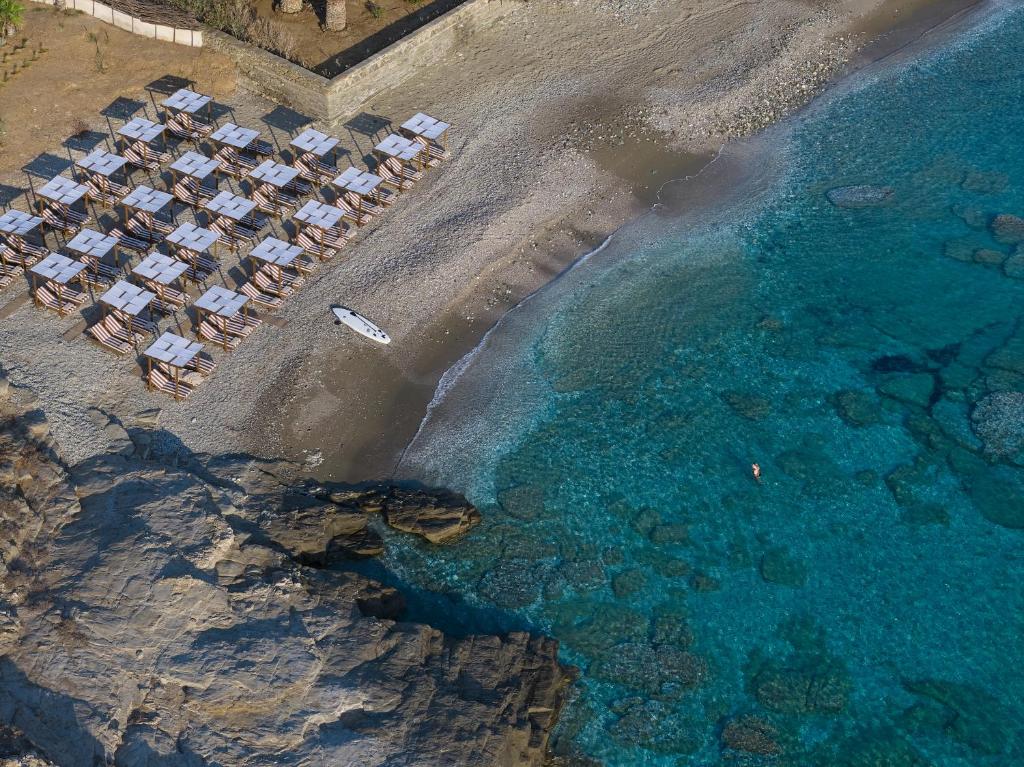 an aerial view of a beach with chairs and the water at Domotel Kea in Koundouros