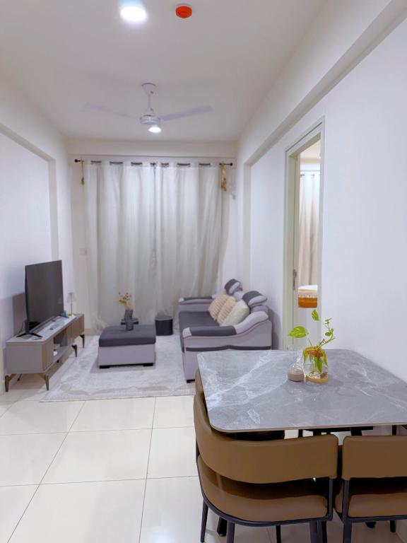 a living room with a couch and a table at Minique stay - spacious 3BR in Furena