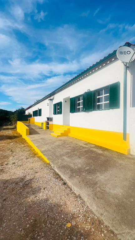 a white and yellow building with a sign next to it at Casa do Rio By Viva a Vida - Alojamentos & Hotels in Constância