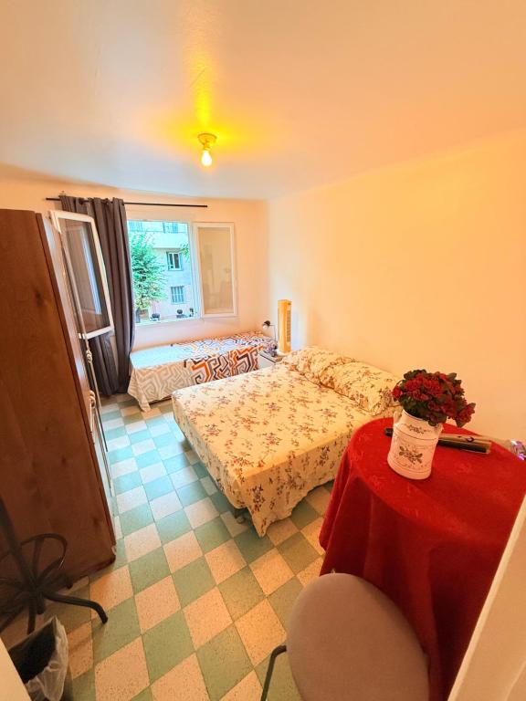 a bedroom with a bed and a table with a table at Twin room in Nice