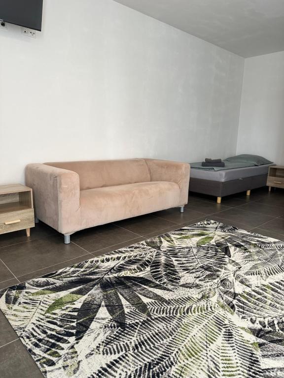 a living room with a couch and a rug at Pension Boardinghaus Dingolfing in Dingolfing