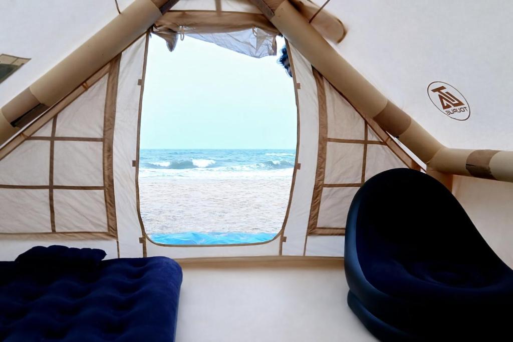 a view of the beach from the inside of a tent at Secret Point Luxury Glamping in Panama
