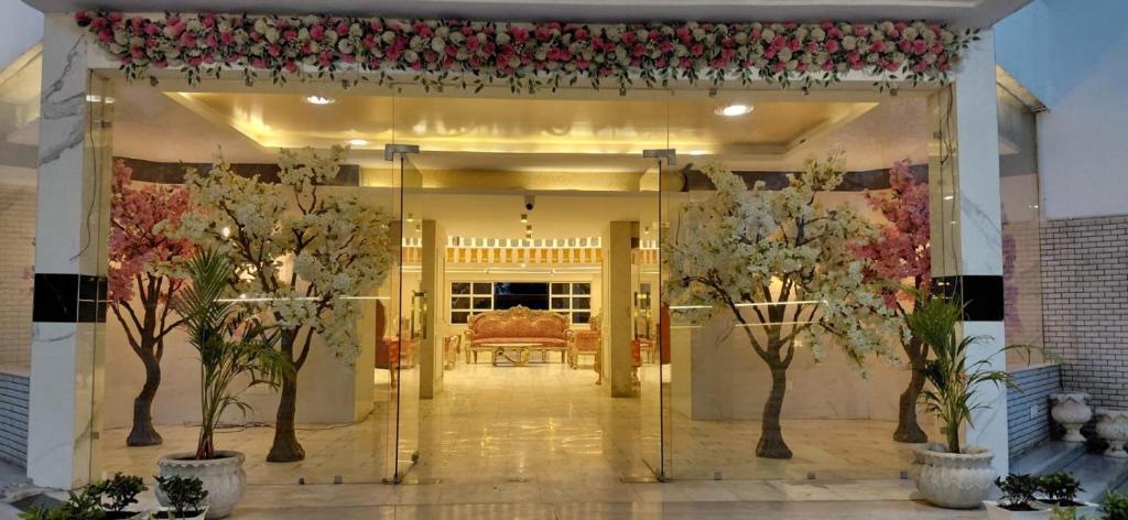 a entrance to a house with trees and flowers at Landmark Resort in Sonīpat