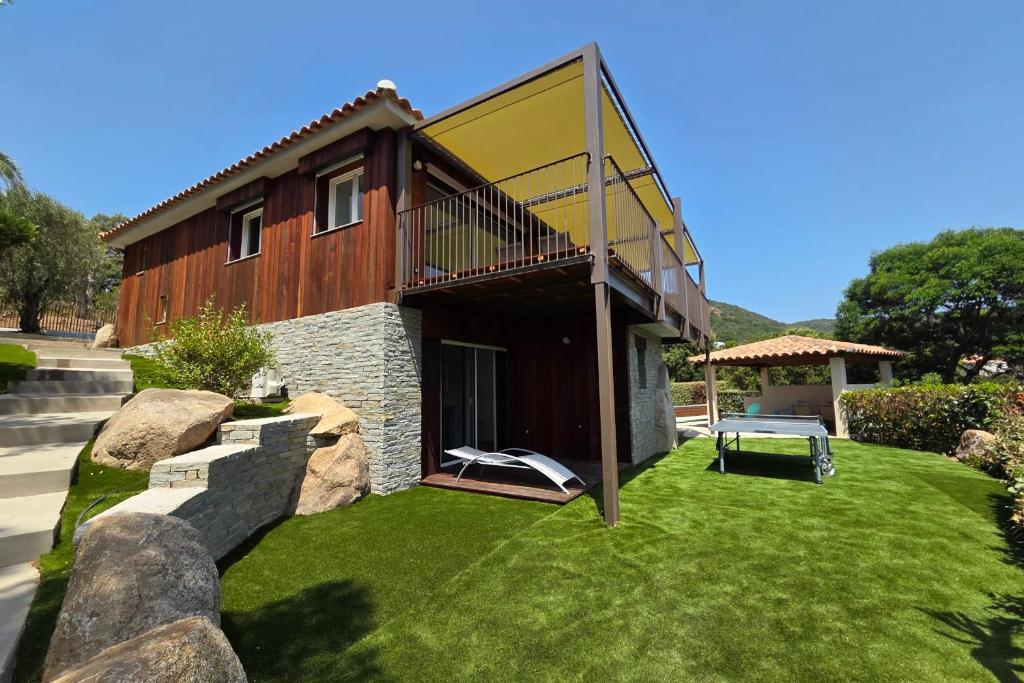 a house with a green lawn in front of it at CASA FUNTA - villa T5 - vue mer- piscine in Sainte-Lucie de Porto-Vecchio