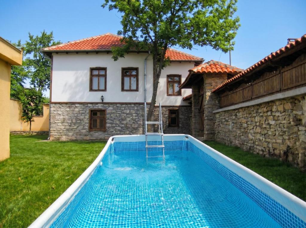 a swimming pool in front of a house at Guesthouse Dryanovo in Dryanovo