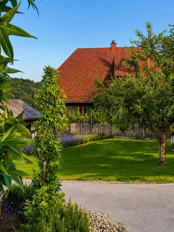 a house with a red roof and a yard at Skoff Original Holzhaus in Eckberg