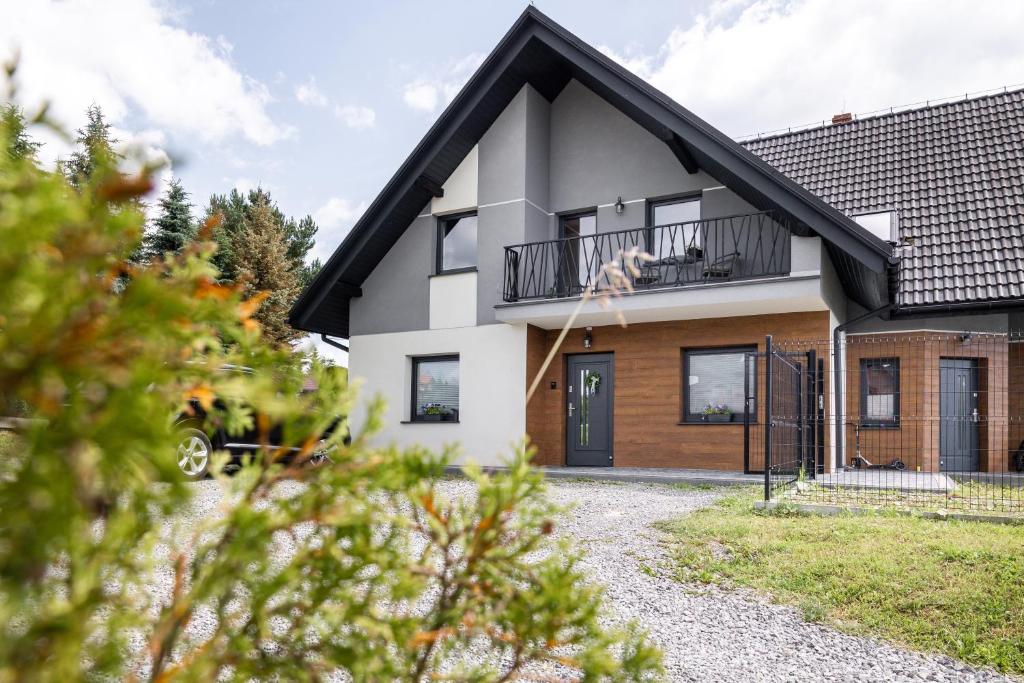 a white house with a black roof at Cozy mountain house - Coolówka pod Babią Górą in Zubrzyca Dolna