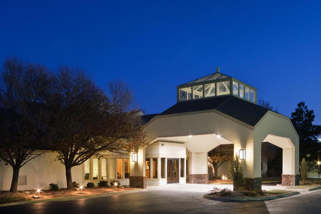 a large white building with a clock tower on top at Endeavor Inn & Suites, Trademark Collection by Wyndham in Topeka