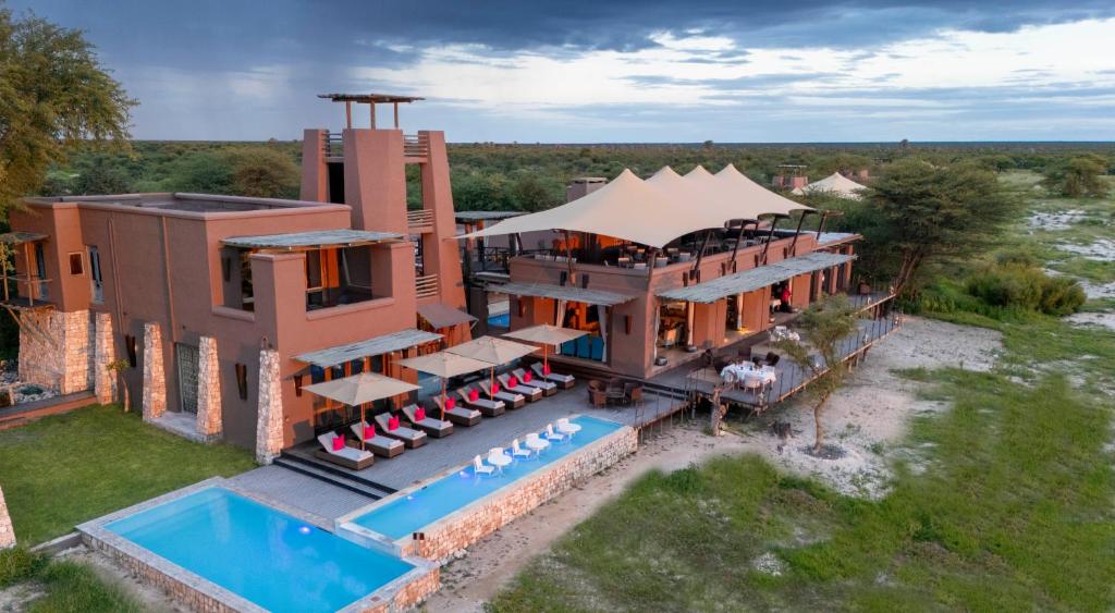an aerial view of a house with a swimming pool at Onguma The Fort in Namutoni Gate