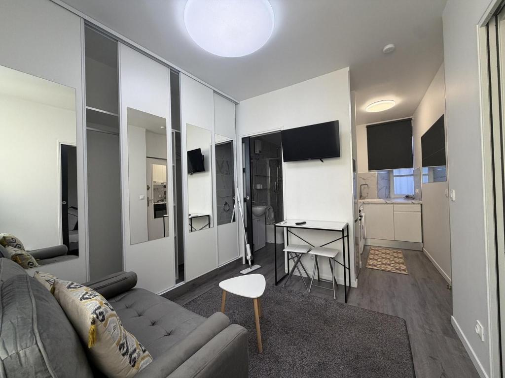a living room with a couch and a table at La suite de Saint régis 1 in Le Puy-en-Velay