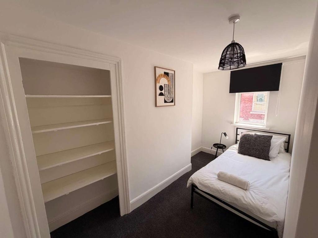 a small bedroom with a bed and a closet at Alexandra View in Goole