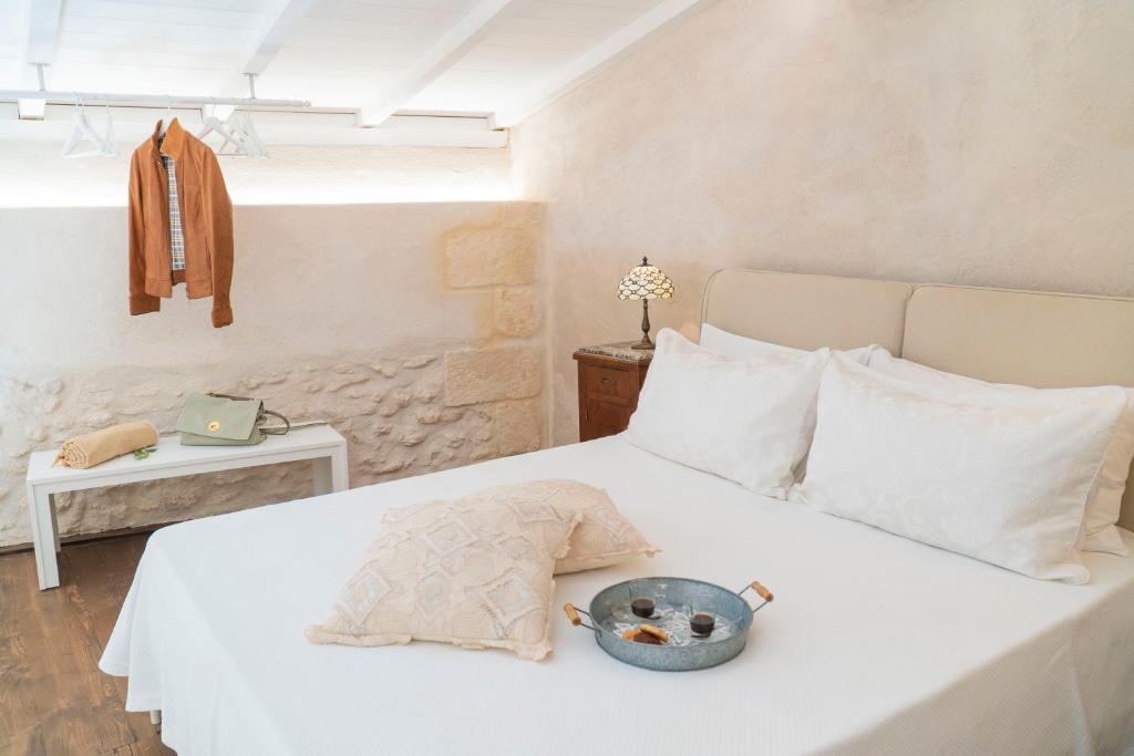 a bedroom with a bed with a bowl of food on it at HISTORIA - Dimore in Corte in Borgagne