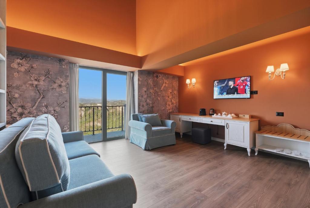 a living room with a couch and chairs and a tv at Agroturizem Cialda in Shkallnur