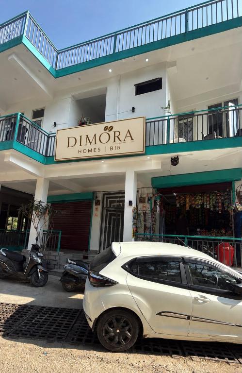 a white car parked in front of a building at Dimora Homes, Bir in Bīr