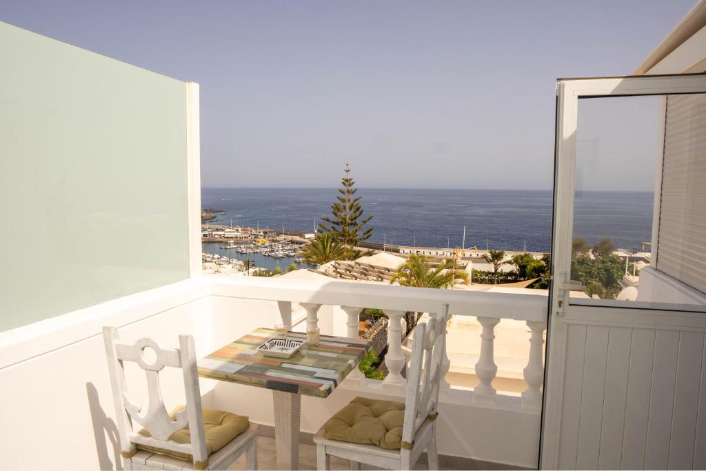 a balcony with a table and a view of the ocean at Apartments Gina y Vista Oceano in Puerto del Carmen
