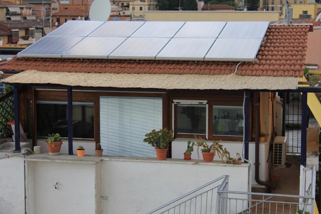 a house with solar panels on the roof at Romantic Studio Apartment Near Park in Rome