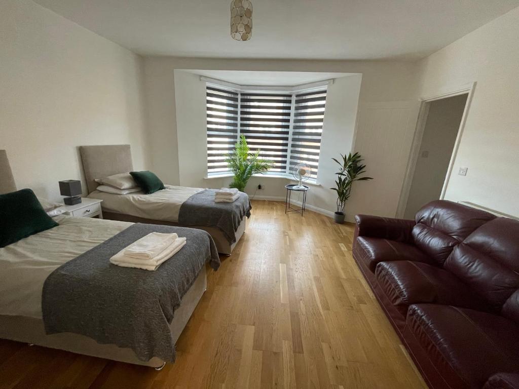 a living room with two beds and a couch at The Nook in Bedford