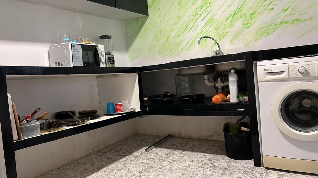 a small kitchen with a washing machine in it at Villa Pinzon in Moià