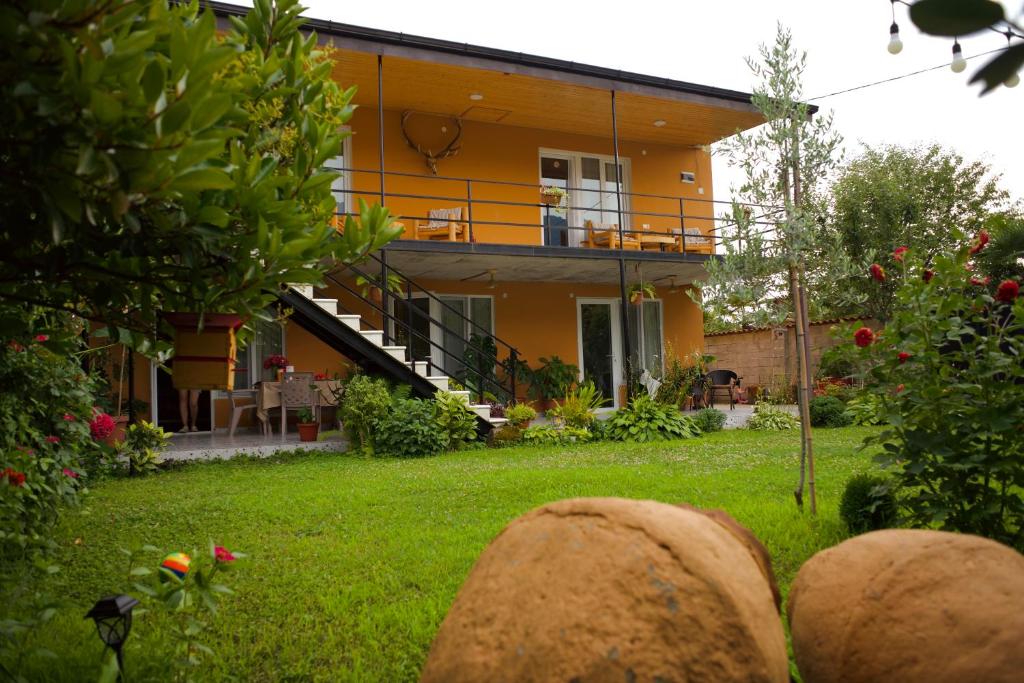a house with a yard with rocks in front of it at Mountain View in Lagodekhi