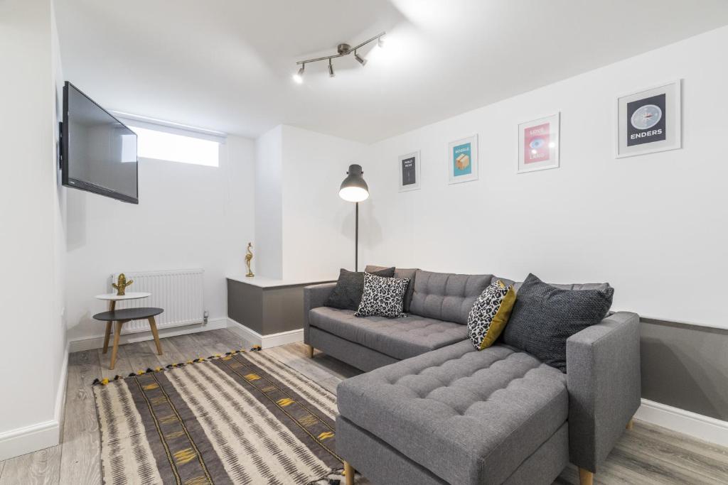 a living room with a couch and a tv at Charming Two Bed - Two Bath Apt (25KM) in Headingley