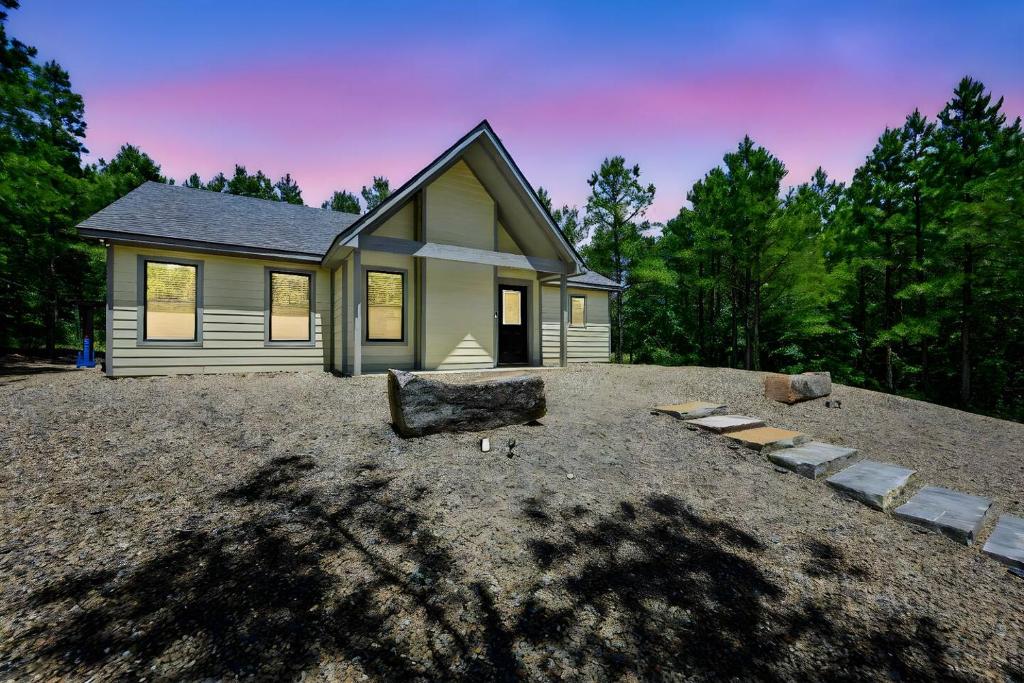 a house sitting on top of a large yard at Private Escape| Hot tub| Fire Pit| Trail Access in Broken Bow