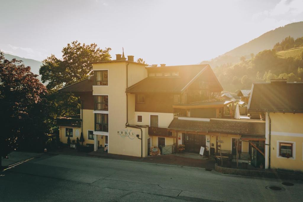 a building on the side of a street at Hotel Gasthof Kröll, 1x Großglockner kostenlos, Kinder bis 12 Jahre frei, Restaurant mit regionaler Küche in Niedernsill