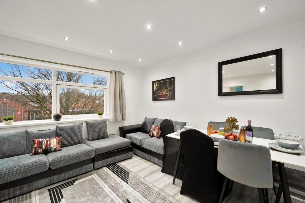 a living room with a couch and a table at K Suites - Nuxley Road in Bexley