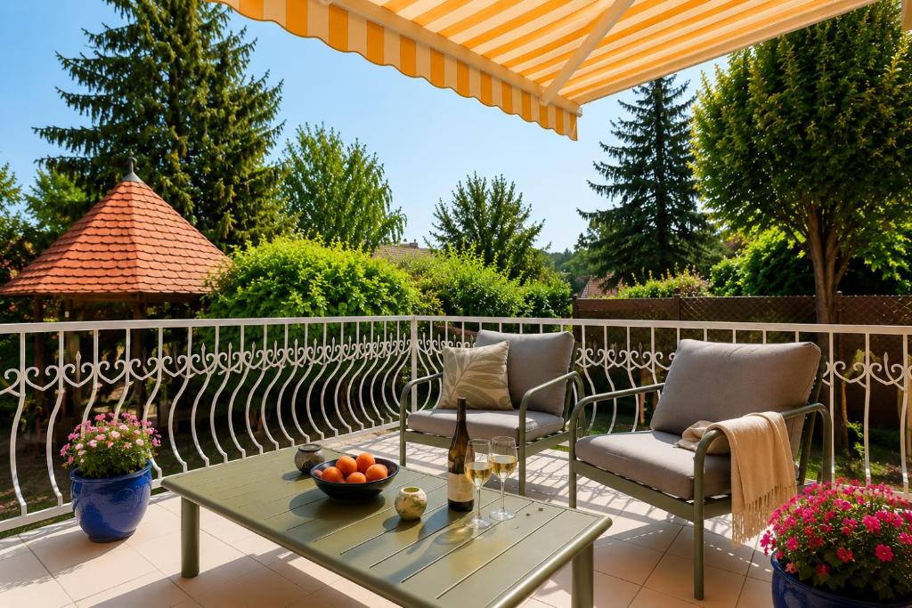 a patio with two chairs and a table at Margaréta Apartman in Balatonudvari