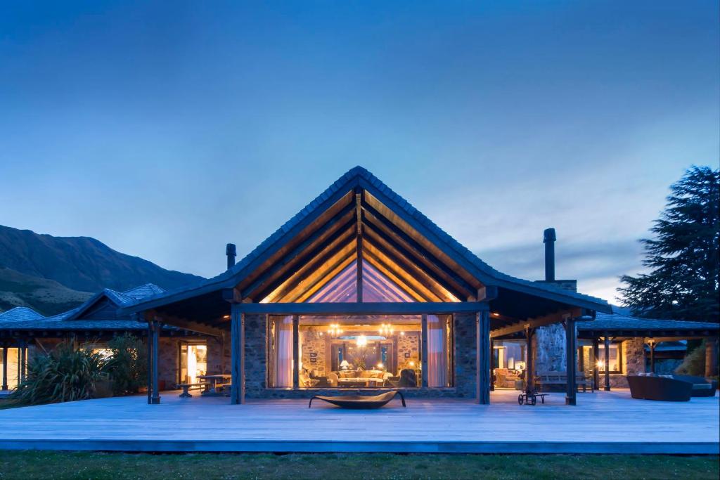 a large house with a large deck at night at Mahu Whenua in Wanaka