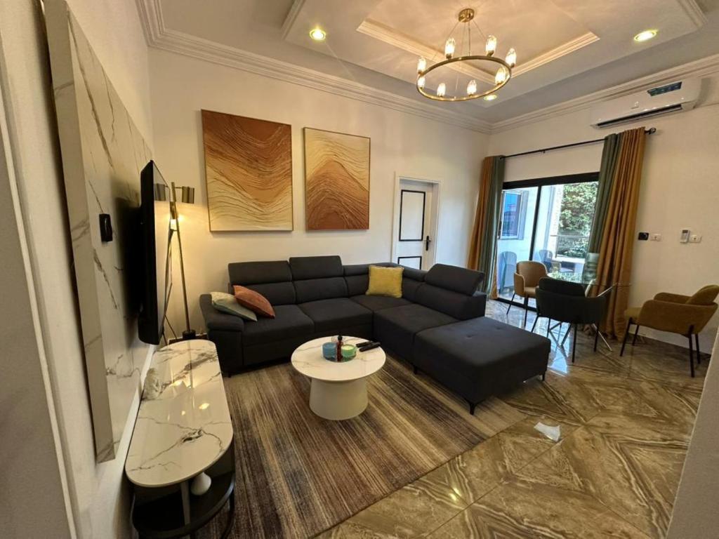 a living room with a couch and a table at Bonapriso in Douala