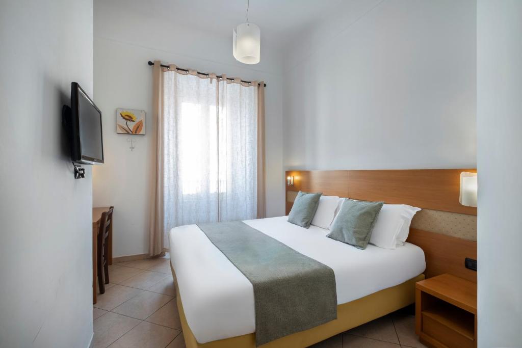 a hotel room with a bed and a television at Hotel Moscatello in Rome