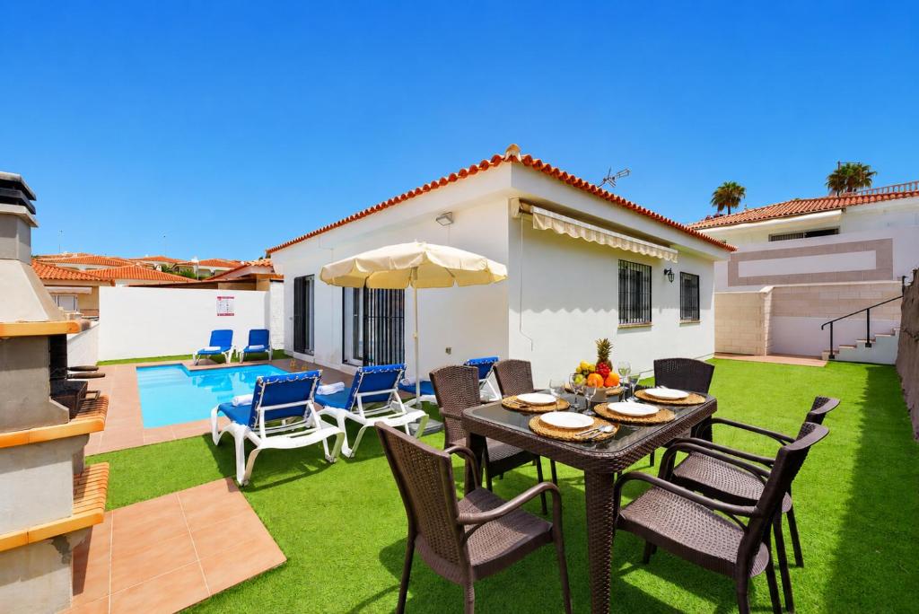 a patio with a table and chairs and a pool at CHALET 273 con PISCINA PRIVADA in Callao Salvaje