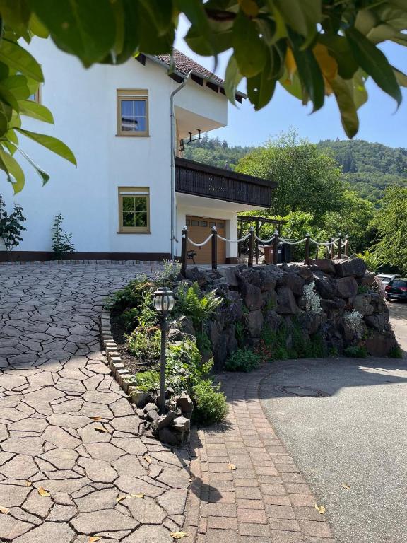 a house with a stone path in front of a building at Ferienwohnung Liliana in Dannenfels
