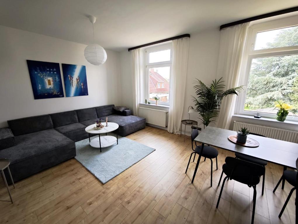 a living room with a couch and a table at Tolle Moderne Altbau Wohnung in Hohenlockstedt