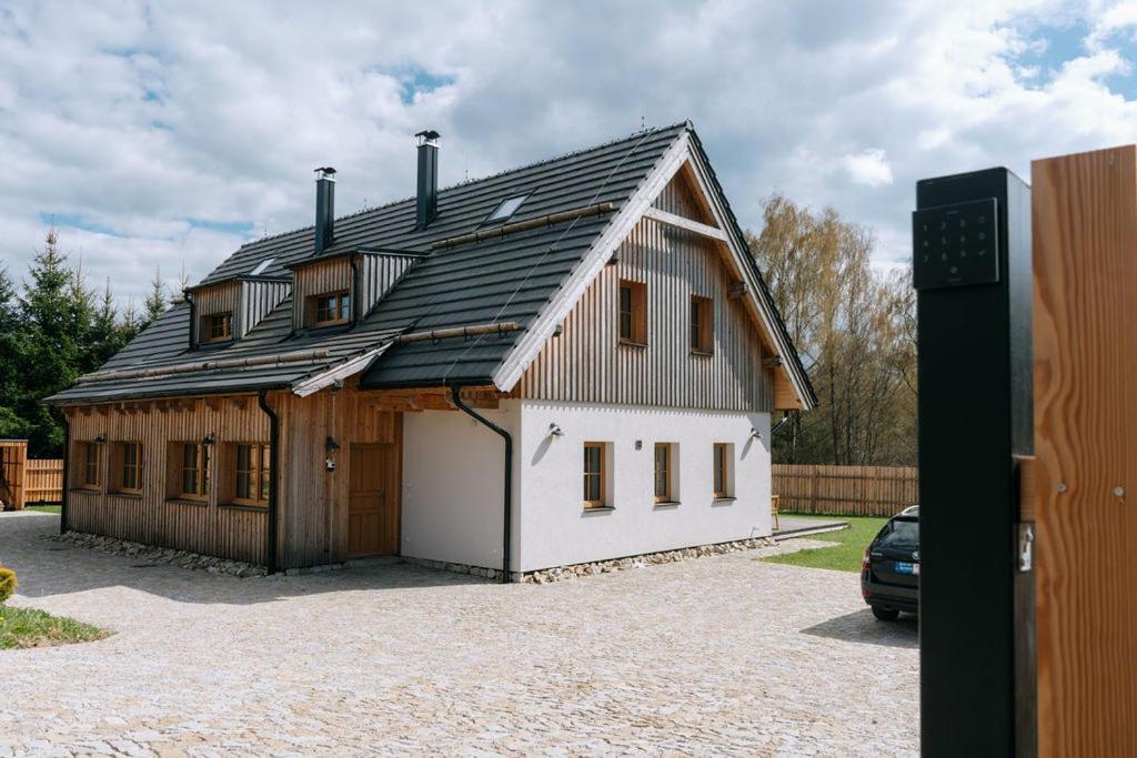 a large white house with a gambrel roof at Výtoň 263 in Přední Výtoň