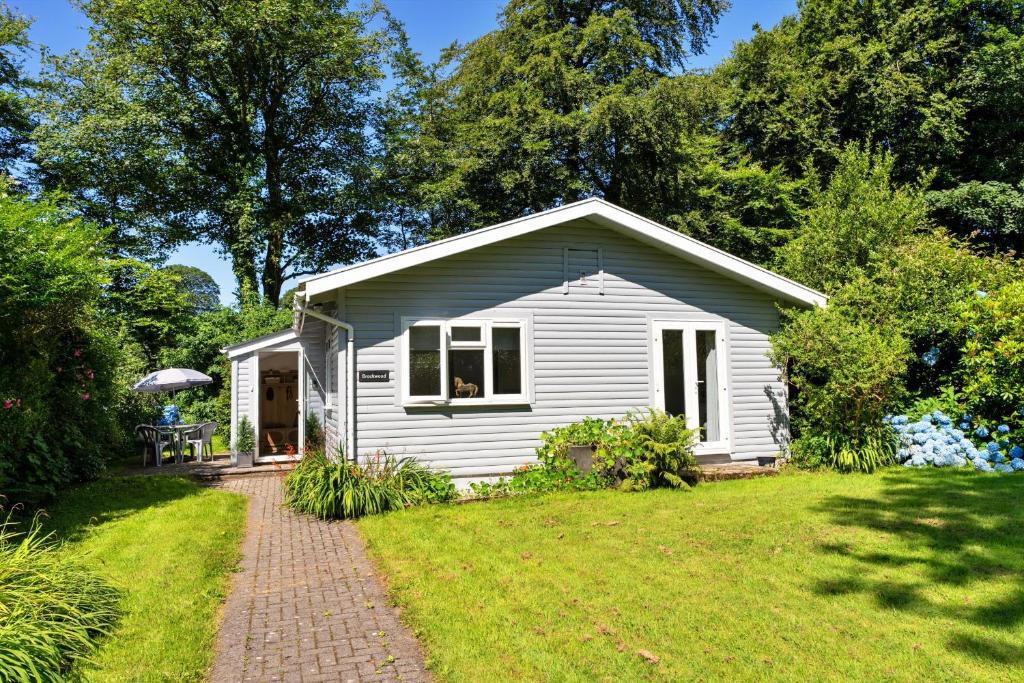 a small white house with a grass yard at Finest Retreats - Brockwood in Bradworthy