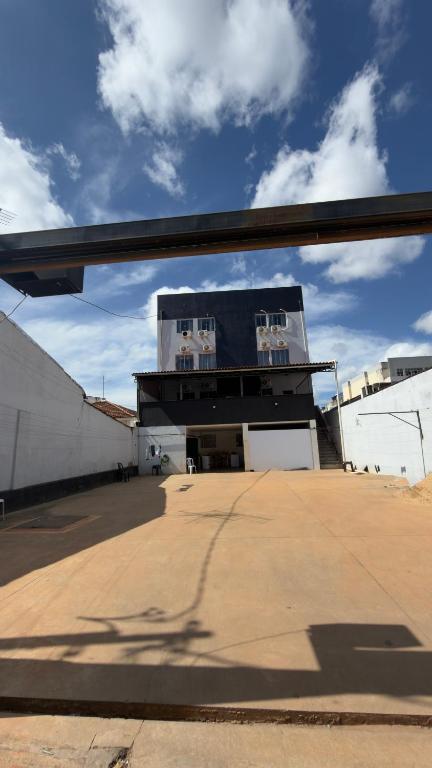 a view of a building from behind a window at BG Hospedagens in Paracatu