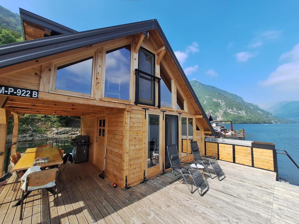 a house on a deck with a view of the water at Splav Zaliv, Perućac in Aluga